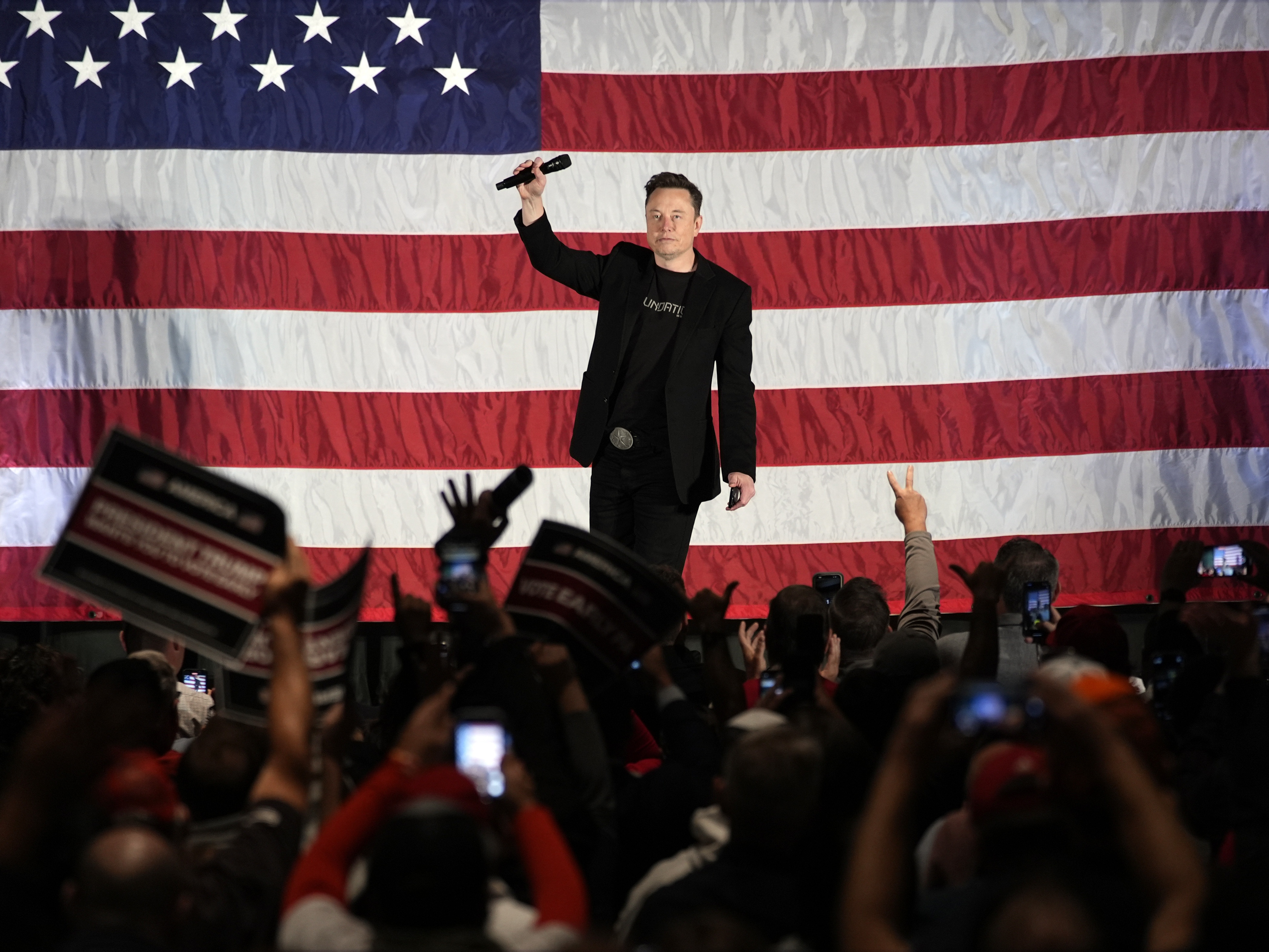 caption: Elon Musk speaks as part of a campaign town hall in support of Republican presidential nominee and former President Donald Trump in Folsom, Pa., on Thursday.