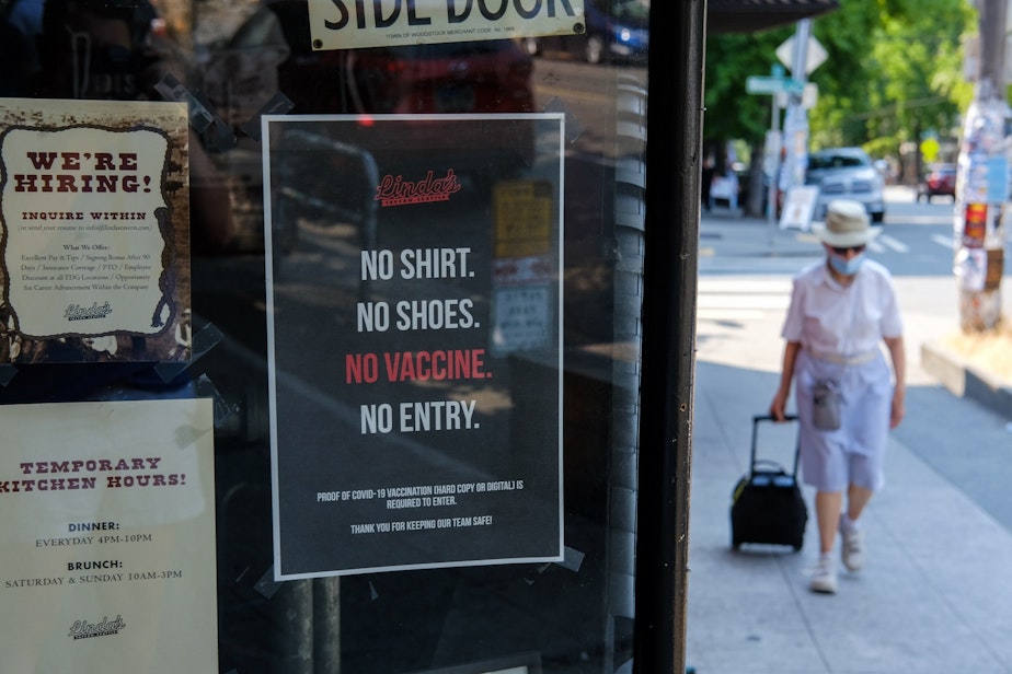 caption: A sign that reads "no shirt, no shoes, no vaccine, no entry" is posted outside Linda's Tavern on Capitol Hill, Monday, August 2, as they and many other area bars and restaurants have begun requiring proof of vaccination for their patrons.