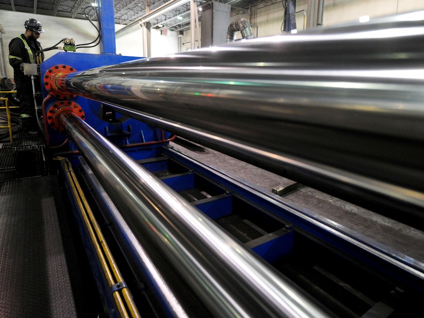 caption: The U.S. is lifting tariffs on Canadian and Mexican steel imports, nearly a year after imposing the duties. Here, a worker is seen at Bri-Steel Manufacturing, which makes seamless steel pipes, in Edmonton, Alberta, Canada.
