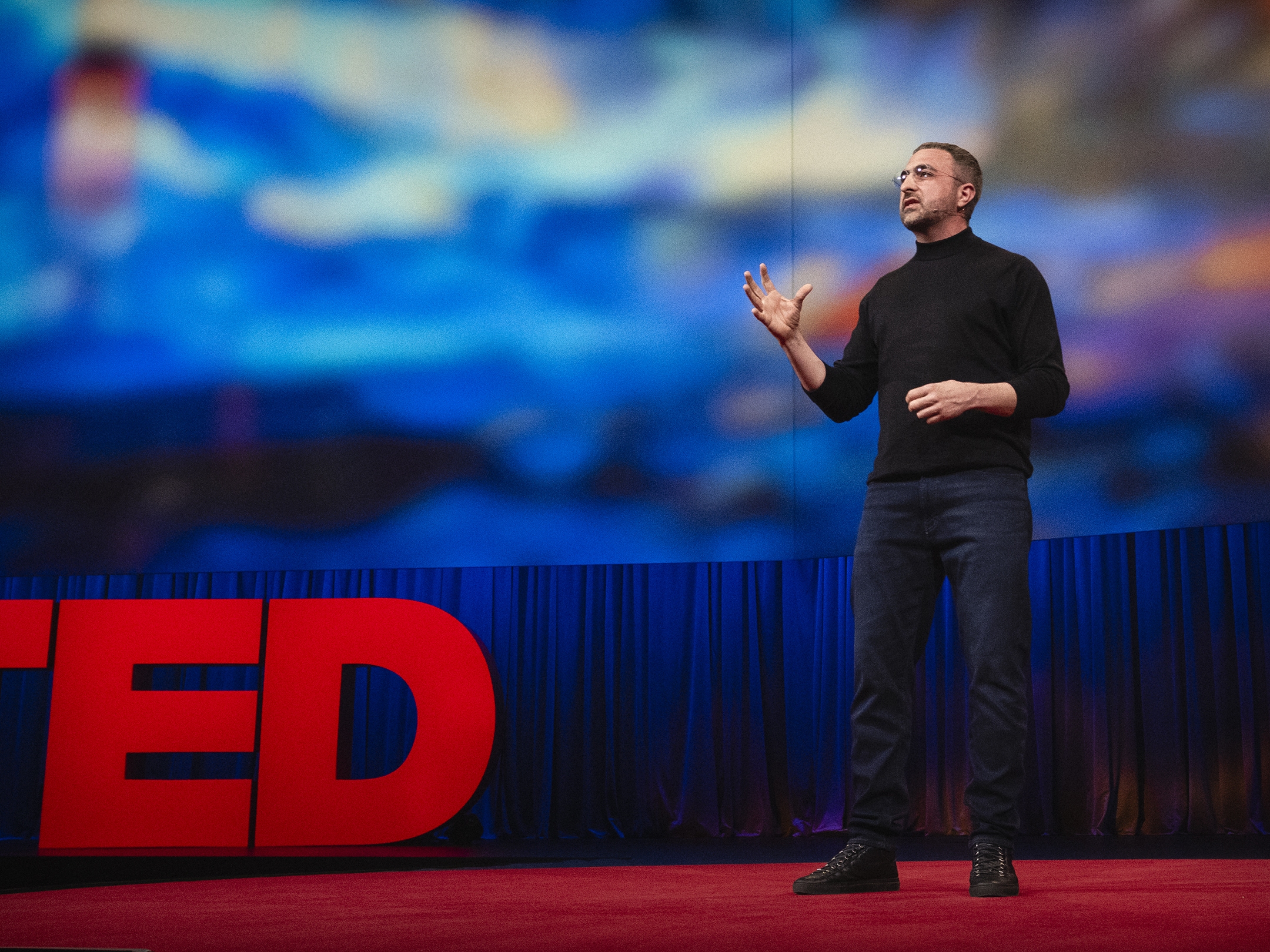 caption: Mustafa Suleyman speaks at TED2024