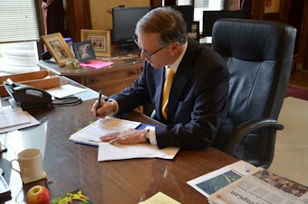 caption: Governor Jay Inslee signs the  request for a Major Disaster Declaration for the Oso mudslide.