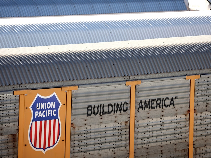 caption: Freight rail cars sit in a rail yard in Wilmington, California, on November 22, 2022. This week, President Biden urged Congress to pass legislation to prevent a rail strike that could have brought trains to a halt nationwide.