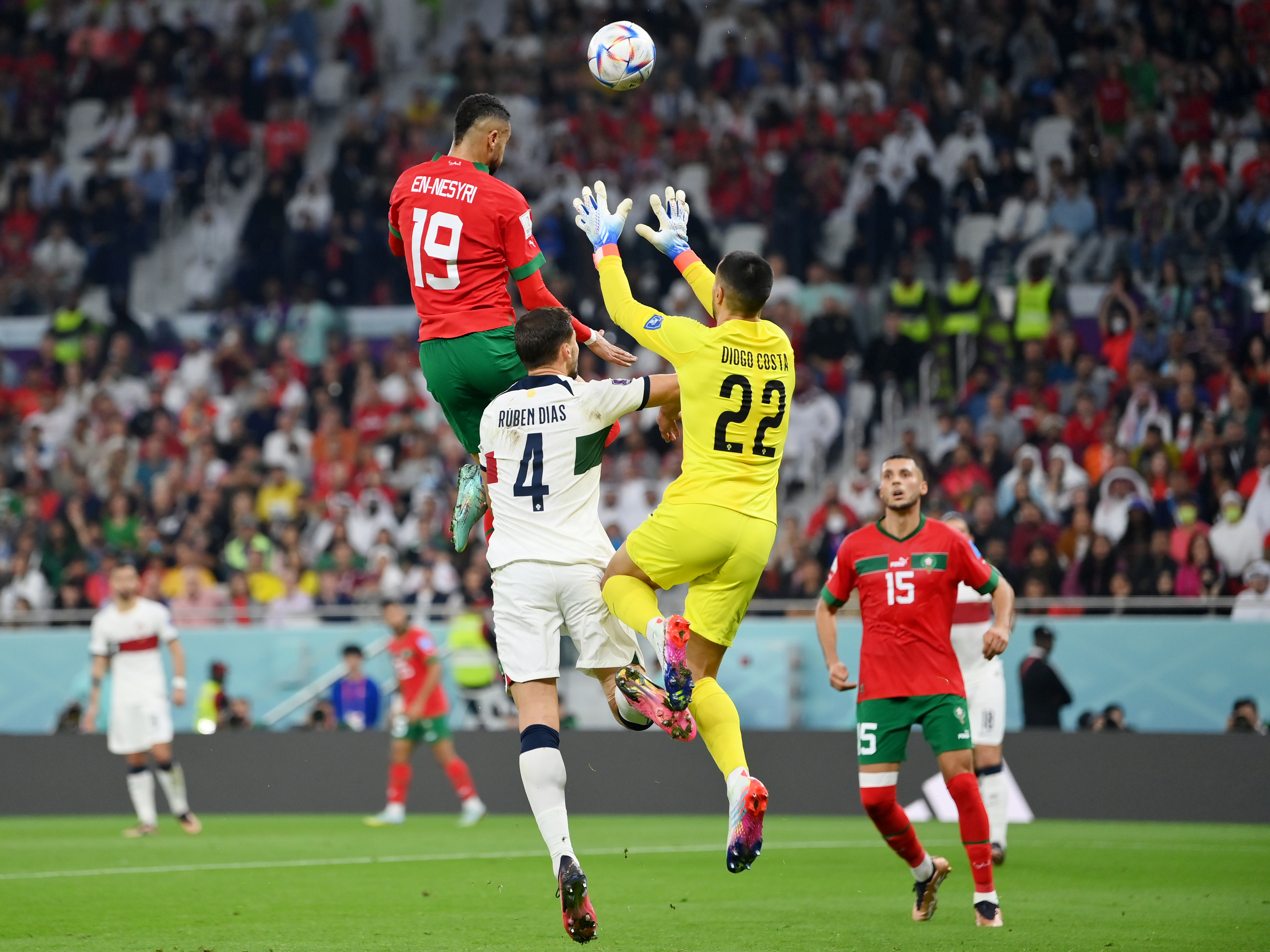 caption: Youssef En-Nesyri of Morocco soars high to head the ball and score the team's first goal during Morocco-Portugal quarterfinal at the World Cup in Qatar on December 10, 2022.