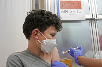 caption: Leo Hahn, 11, gets the first shot of the Pfizer Covid-19 vaccine, Tuesday, Nov. 9, 2021, at the University of Washington Medical Center in Seattle. Last week, U.S. health officials gave the final signoff to Pfizer's kid-size Covid-19 shot, a milestone that opened a major expansion of the nation's vaccination campaign to children as young as 5. 
