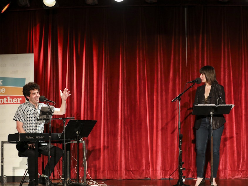 caption: Julian Velard and Ophira Eisenberg play a game called The Order of the Universe on Ask Me Another at the Bell House in Brooklyn, New York.