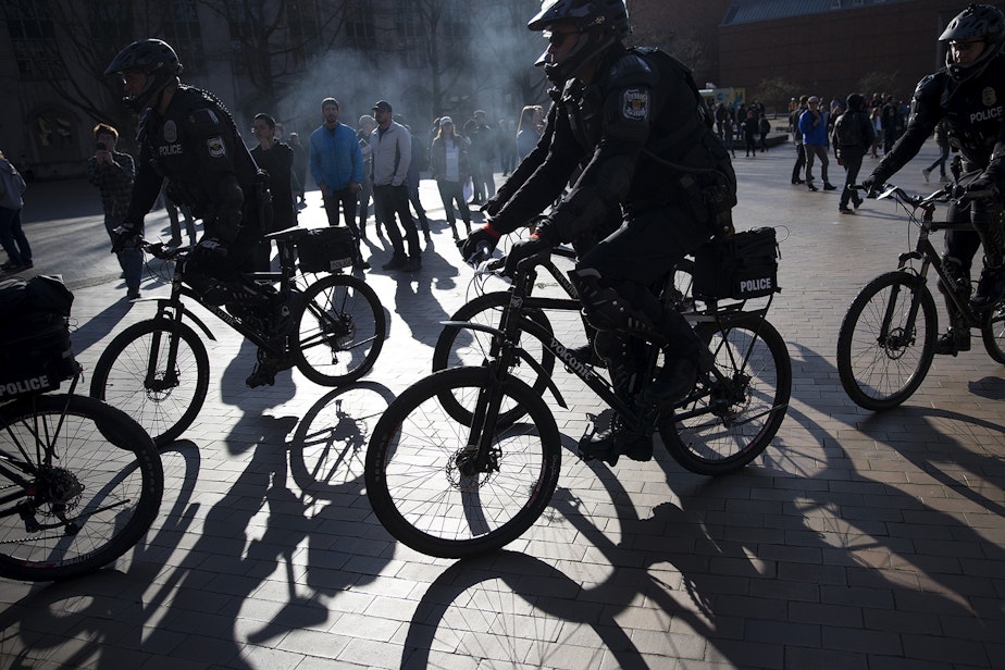 caption: Police officers form a line on Saturday, Feb. 10, 2018, outside of a College Republicans rally at Red Square on the University of Washington campus in Seattle.