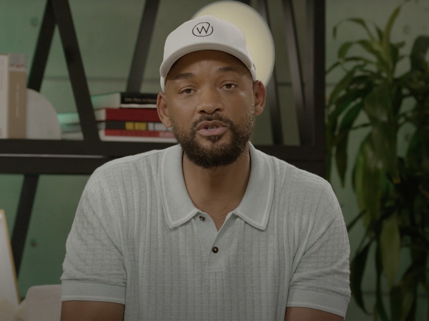 caption: Will Smith apologizes to Chris Rock in a video on YouTube.