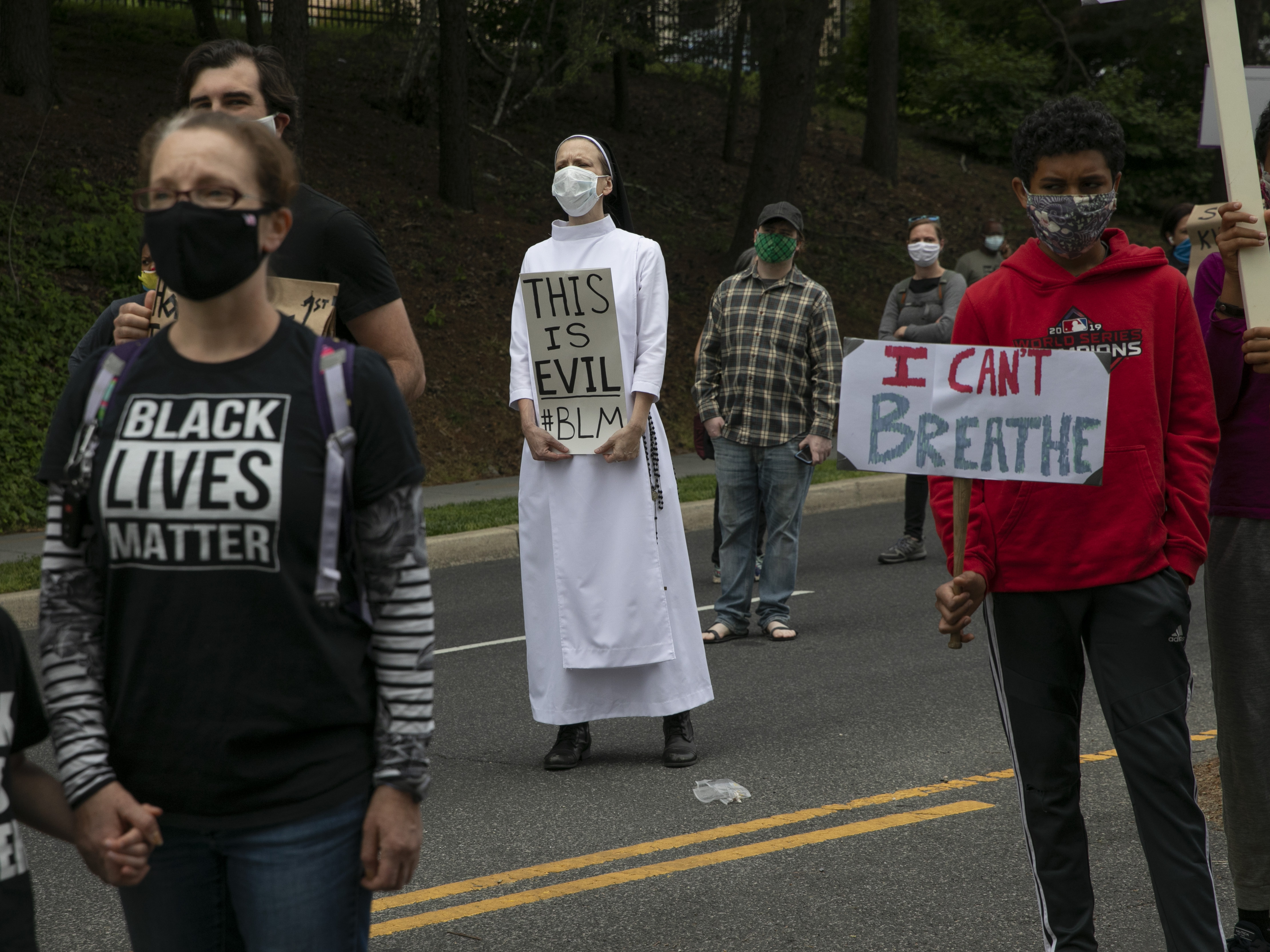 caption: Pope Francis says he is praying for George Floyd "and of all those others who have lost their lives as a result of the sin of racism." He's also calling for reconciliation in the U.S. Here, Sister Quincy Howard, center, a Dominican nun, protests the arrival of President Trump to the Saint John Paul II National Shrine in Washington Tuesday.