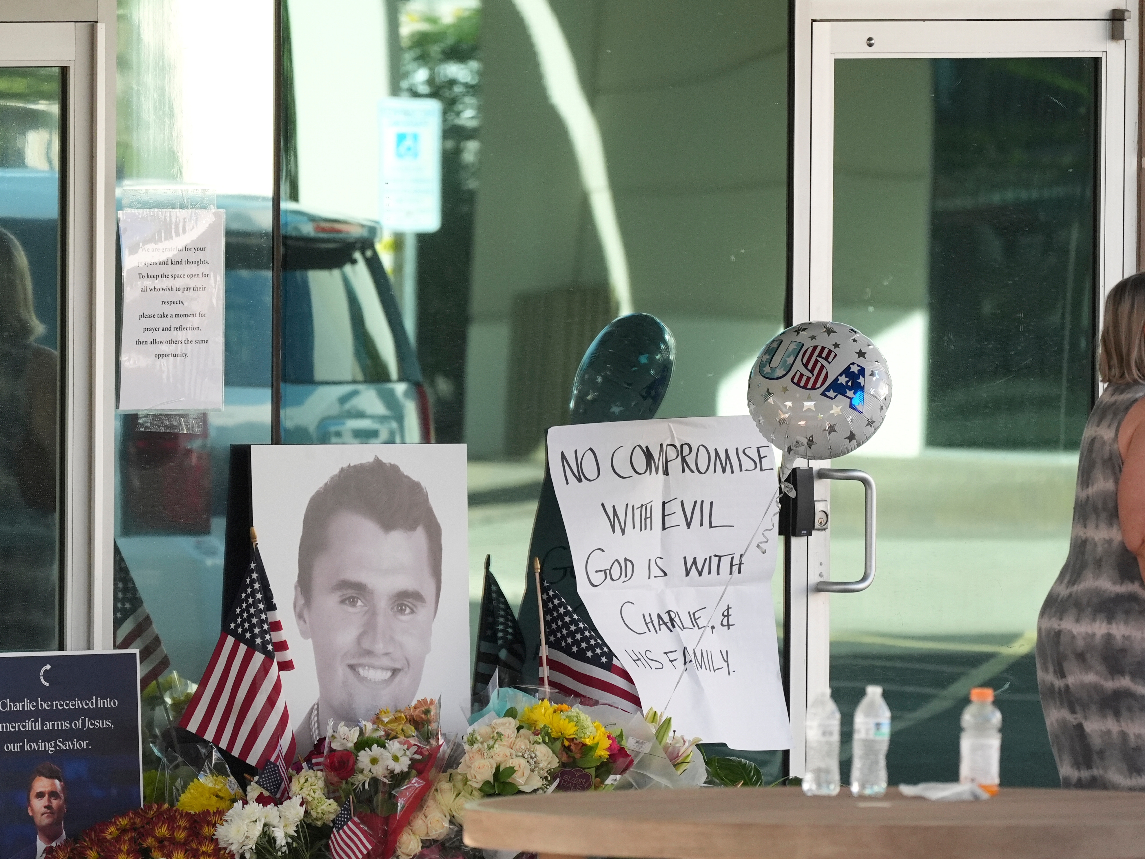 caption: Well-wishers pay their respects at a makeshift memorial at the national headquarters of Turning Point USA in Phoenix after the shooting death of Charlie Kirk, the co-founder and CEO of the organization, during a Utah college event Wednesday, Sept. 10, 2025.