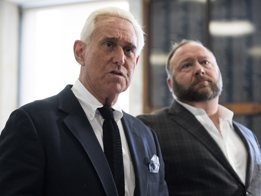 caption: Roger Stone, left, and Alex Jones hold a press conference before attending a House Judiciary Committee hearing in 2018.