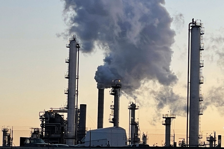 caption: Steam and invisible, heat-trapping carbon dioxide billow from the Marathon Petroleum Corporation refinery in Anacortes, Washington, in April 2022.
