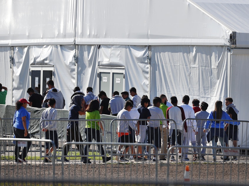 caption: Children line up to enter a tent at the Homestead Temporary Shelter for Unaccompanied Children in Homestead, Fla., in Feb. 2019 The American Civil Liberties Union and other attorneys filed a lawsuit on behalf of thousands of immigrant families who were separated at the U.S.-Mexico border on Oct. 3, 2019.