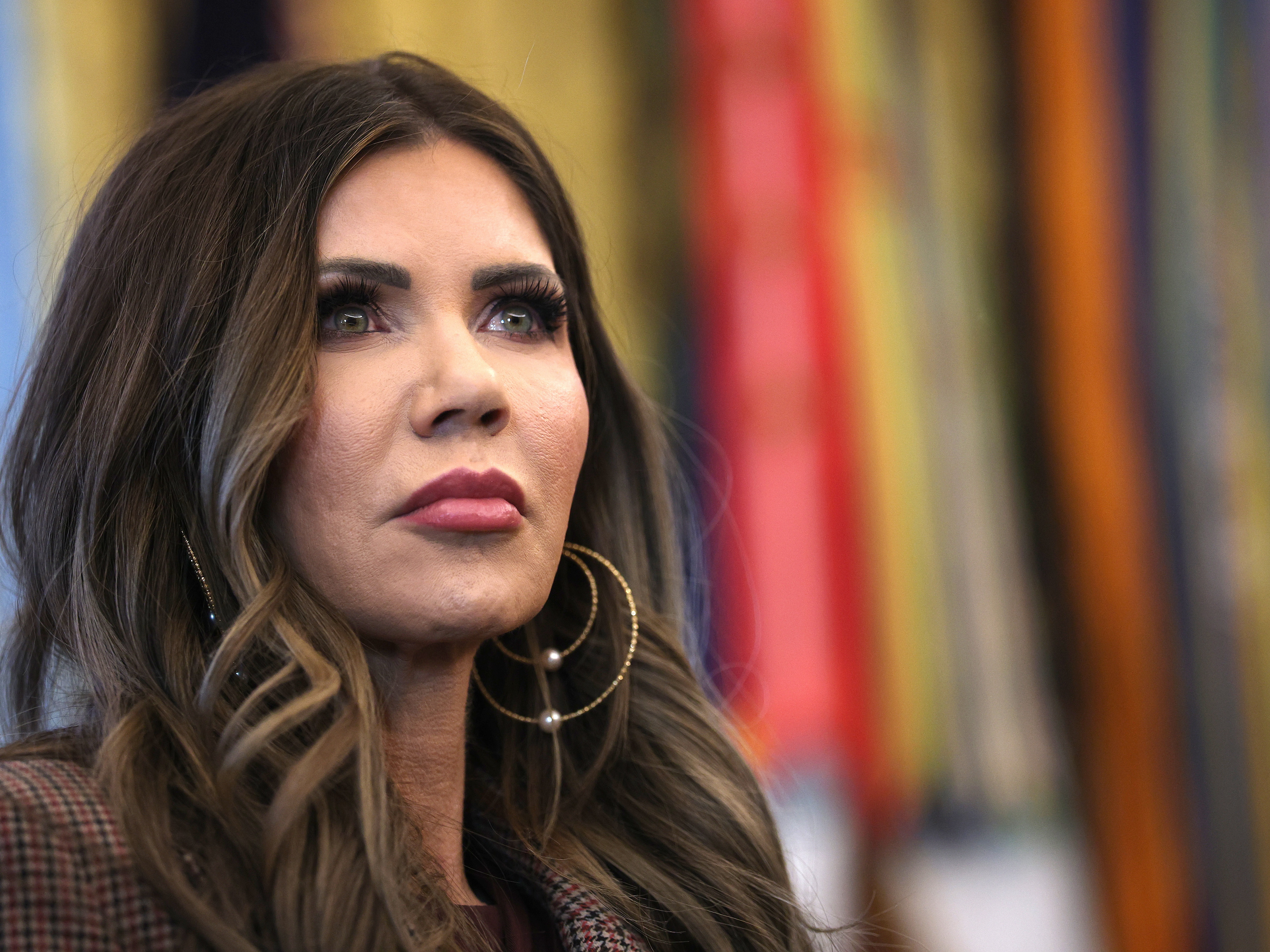 caption: Homeland Security Secretary Kristi Noem attends a meeting in the Oval Office on Nov. 17, 2025.