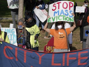 caption: Protesters call for support for tenants and homeowners at risk of eviction during a demonstration on Oct. 11 in Boston. A federal moratorium on evictions is set to expire at the end of December.