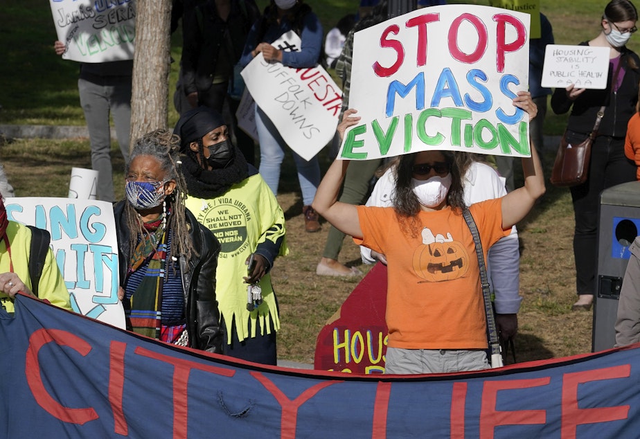 caption: Protesters call for support for tenants and homeowners at risk of eviction during a demonstration on Oct. 11 in Boston. A federal moratorium on evictions is set to expire at the end of December.