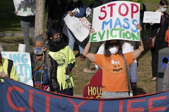caption: Protesters call for support for tenants and homeowners at risk of eviction during a demonstration on Oct. 11 in Boston. A federal moratorium on evictions is set to expire at the end of December.