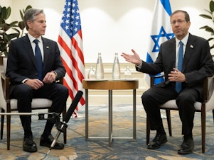 caption: U.S. Secretary of State Antony Blinken, left, and Israel's President Isaac Herzog meet in Tel Aviv, Israel, on Thursday following the announcement of an extension of the truce between Israel and Hamas just before it was due to expire.