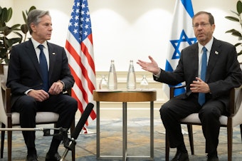 caption: U.S. Secretary of State Antony Blinken, left, and Israel's President Isaac Herzog meet in Tel Aviv, Israel, on Thursday following the announcement of an extension of the truce between Israel and Hamas just before it was due to expire.