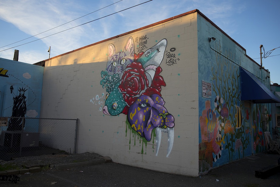 caption: Murals are on display on the back The Fish Store on Thursday, December 6, 2018, along Lake City Way Northeast in Seattle.