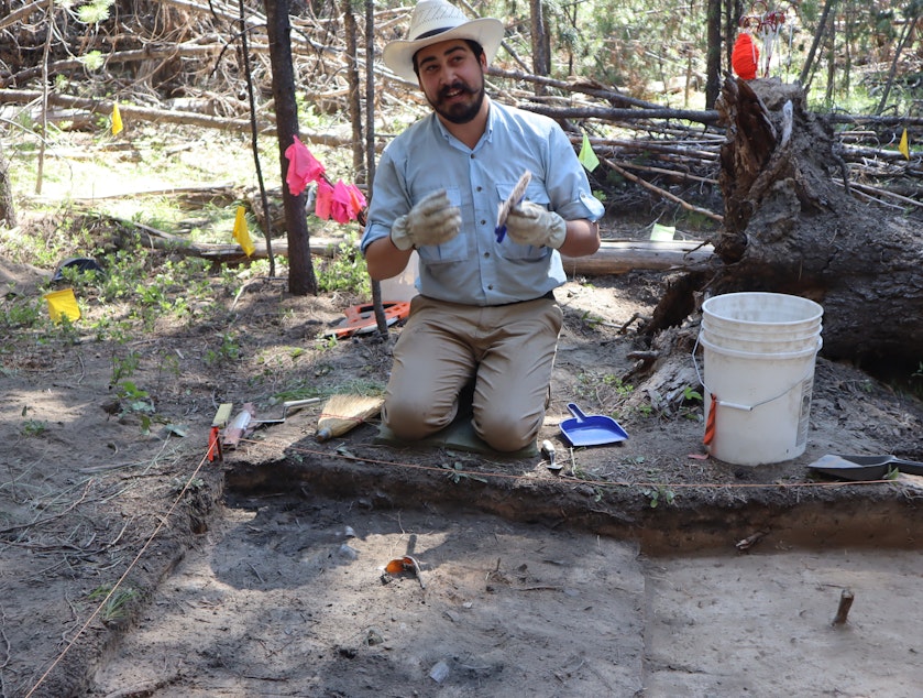 caption: Southern Oregon University's Keoni Diacamos at work on July 21 excavating the site of a home in the vanished company town that once surrounded the Baker White Pine Mill.