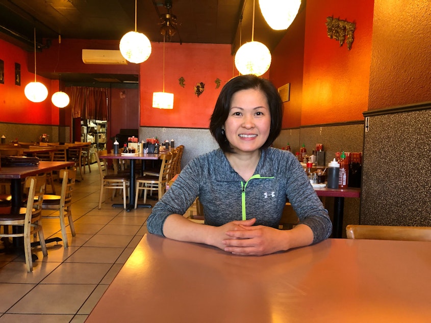 caption: Iris Tran poses for a portrait at Than Vi, a Vietnamese restaurant she co-owns in the University District. 