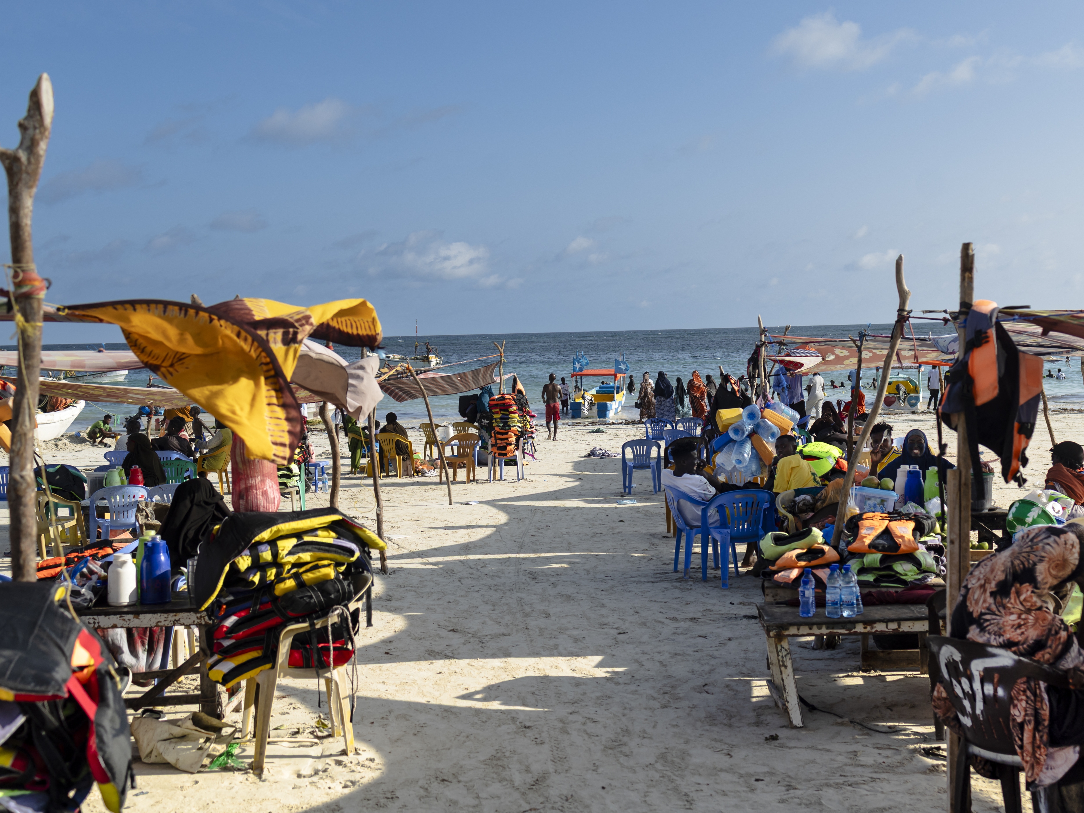 caption: Vendors hawking food and flotation devices wait for visitors at Lido beach in Mogadishu on Nov. 10.