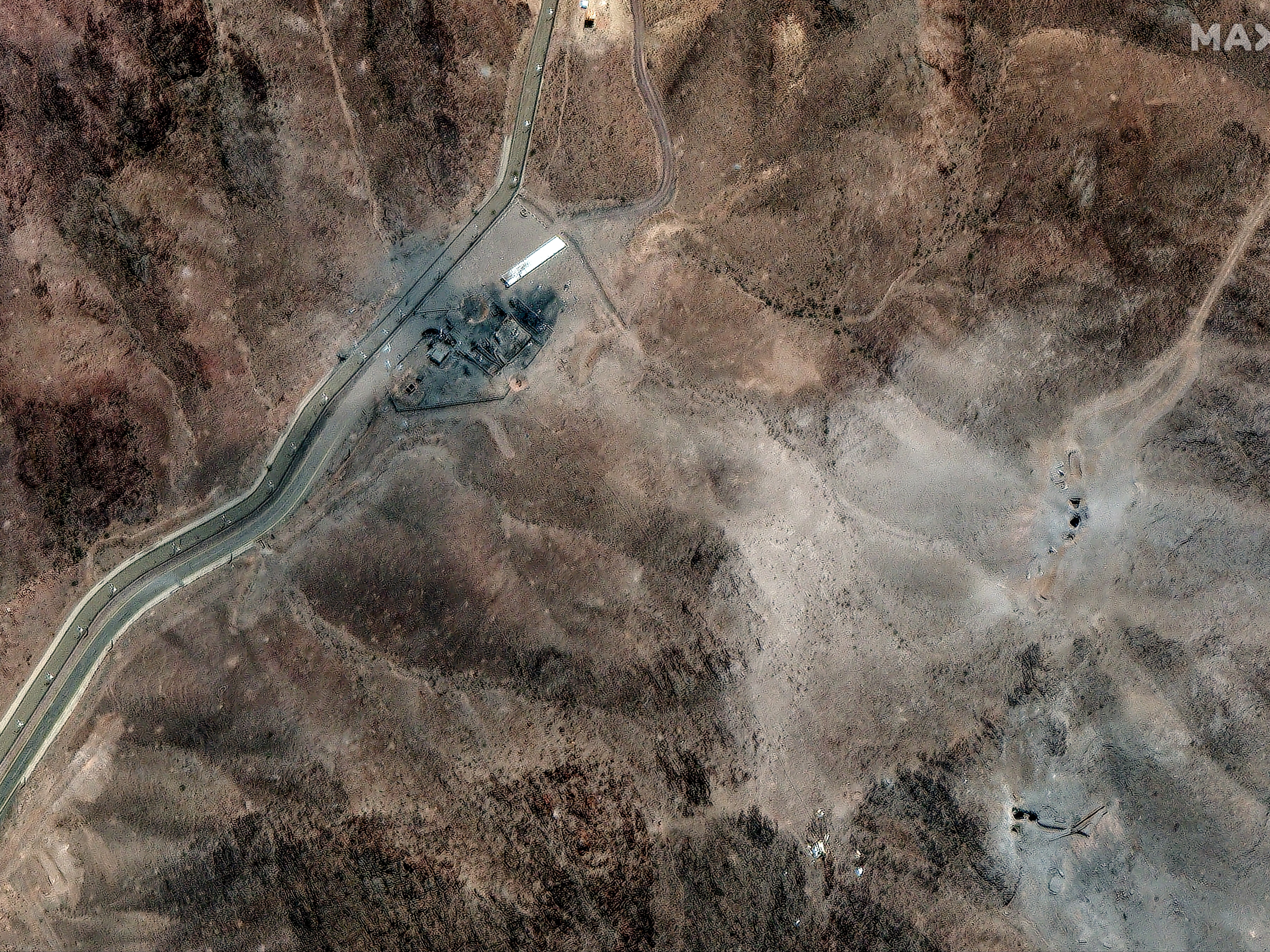 caption: A satellite image of Iran's Fordo nuclear site shows clusters of new craters likely caused by U.S. bunker buster bombs dropped over the weekend following orders by President Trump.