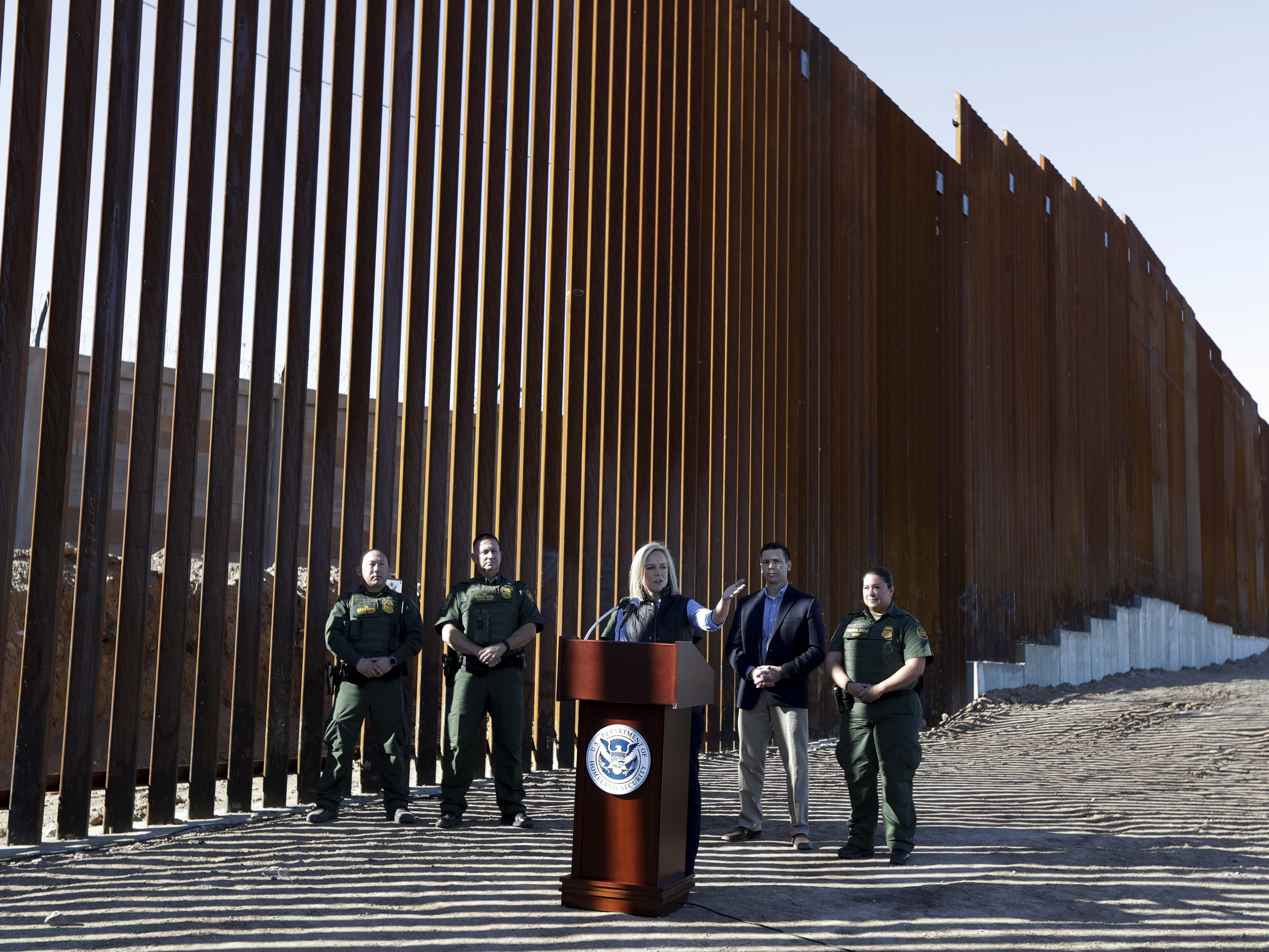 caption: U.S. Department of Homeland Security Secretary Kirstjen Nielsen speaks in front of a newly fortified border wall structure in Calexico, Calif. in October. A federal court ruled Monday that DHS has broad authority to waive environmental regulations in the name of border security.