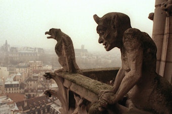 caption: Gargoyles watch over the streets of Paris from the top of the Notre Dame Cathedral in 1996.