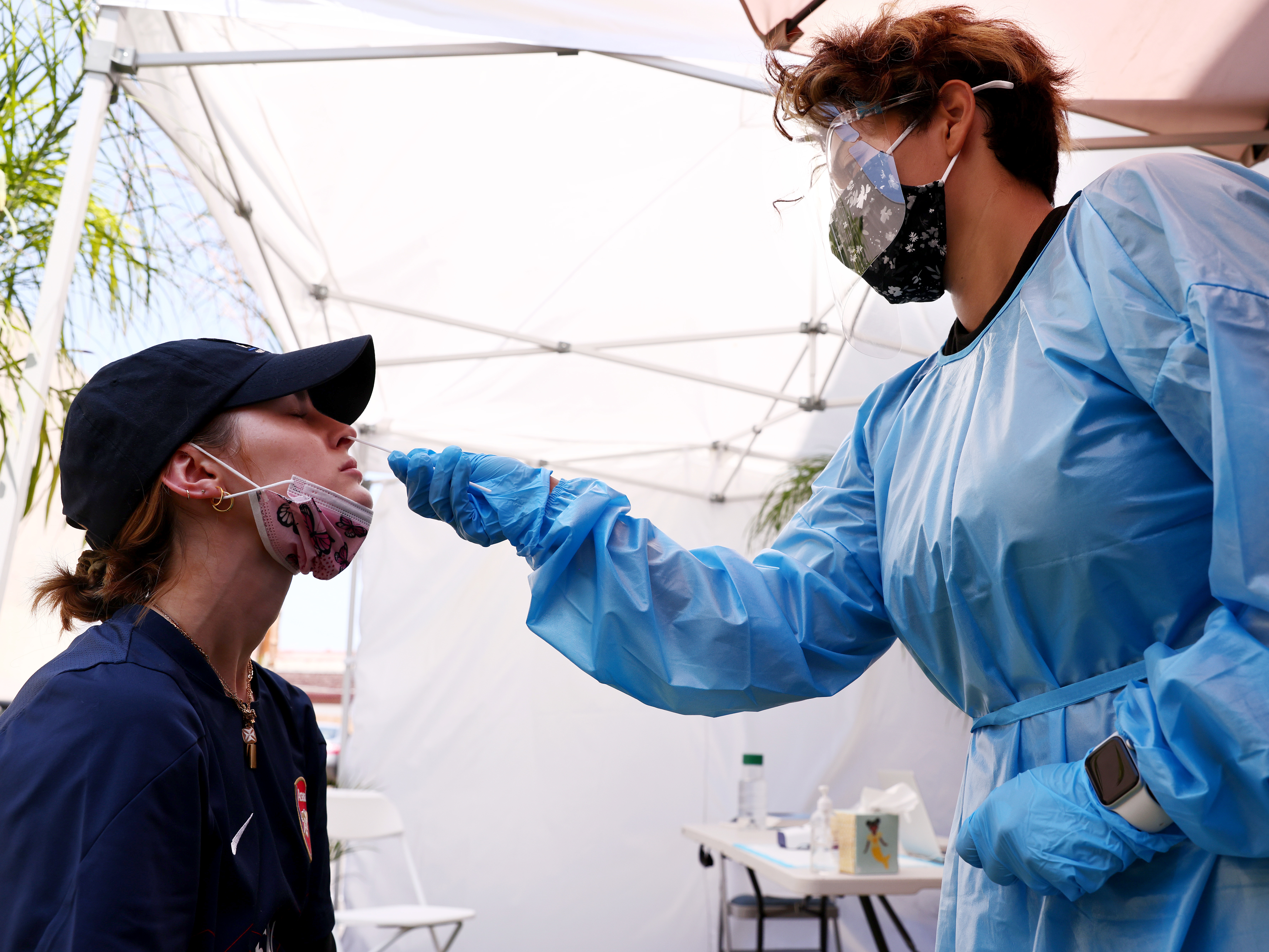 caption: A medical assistant administers a coronavirus test last week in Los Angeles. COVID-19 cases are on the rise as the highly transmissible delta variant has become the dominant coronavirus strain in the United States.