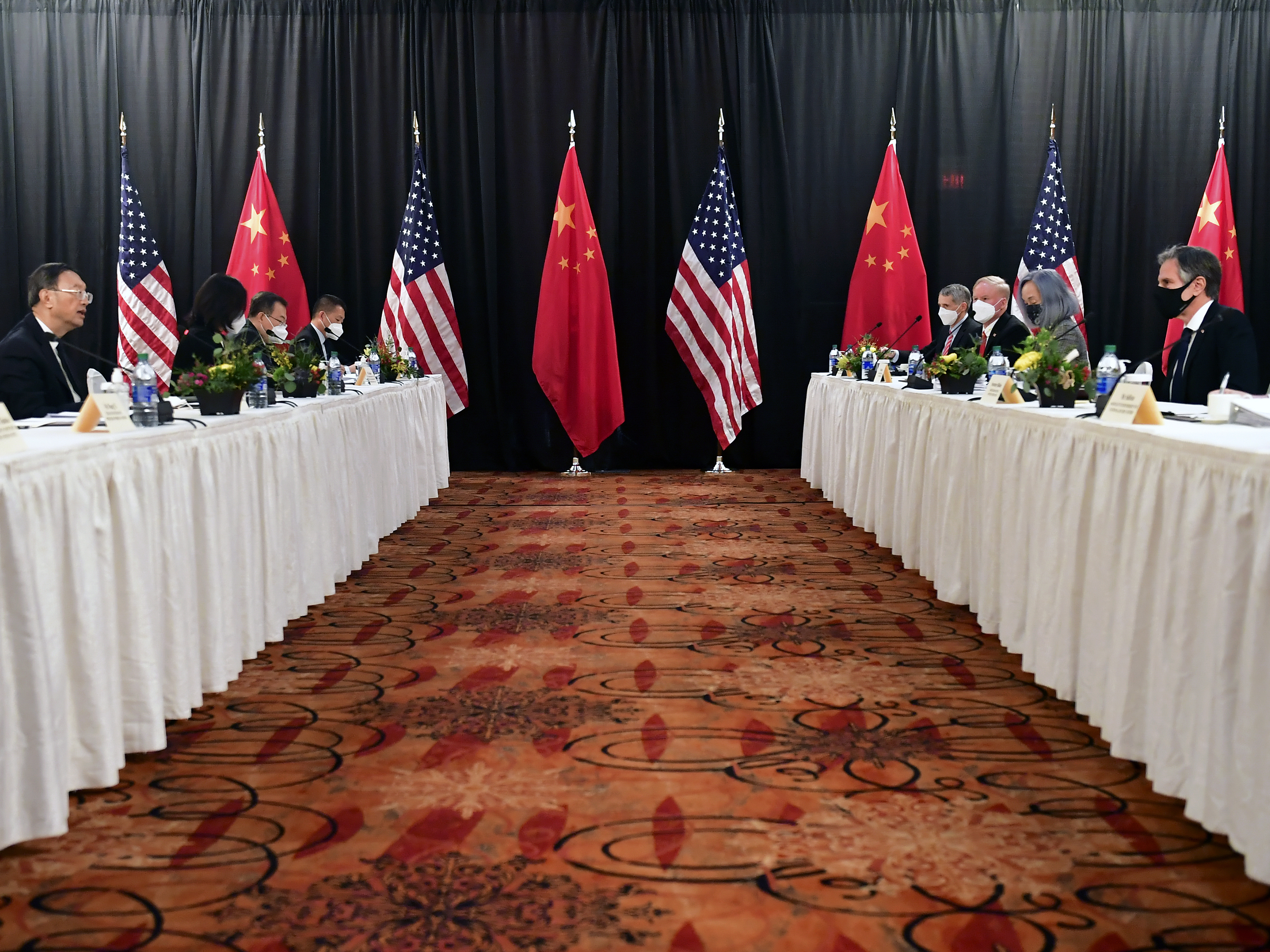 caption: Secretary of State Antony Blinken (second from right), joined by national security adviser Jake Sullivan (right), speaks while facing Chinese Communist Party foreign affairs chief Yang Jiechi (second from left) and China's State Councilor Wang Yi (left) at the opening session of U.S.-China talks at the Captain Cook Hotel in Anchorage, Alaska on Thursday.
