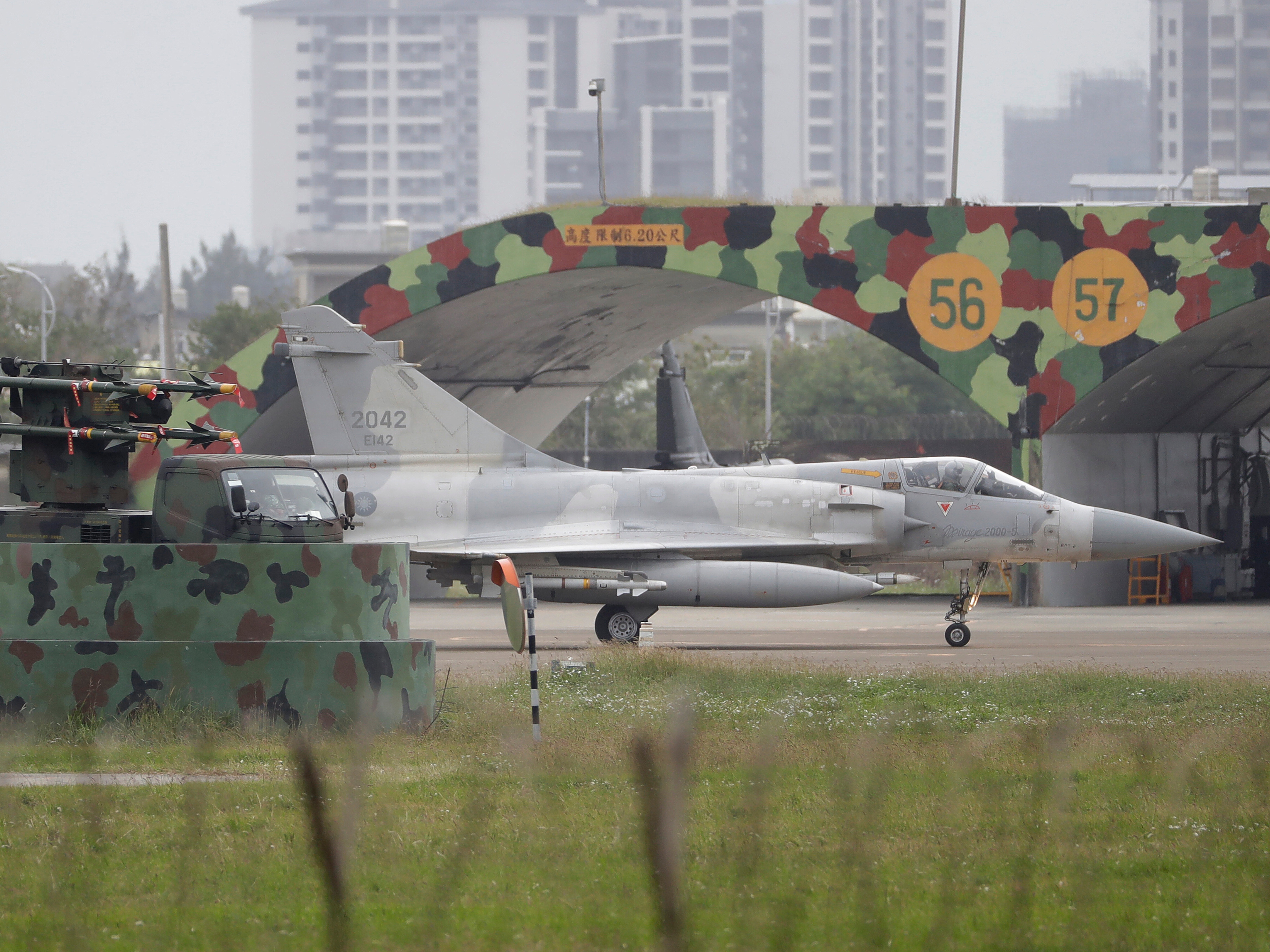 caption: A Taiwan's Mirage 2000 fighter jet runs past an airplane fort at an airbase in Hsinchu, northern Taiwan, Tuesday, Dec. 30, 2025. (AP Photo/Chiang Ying-ying)