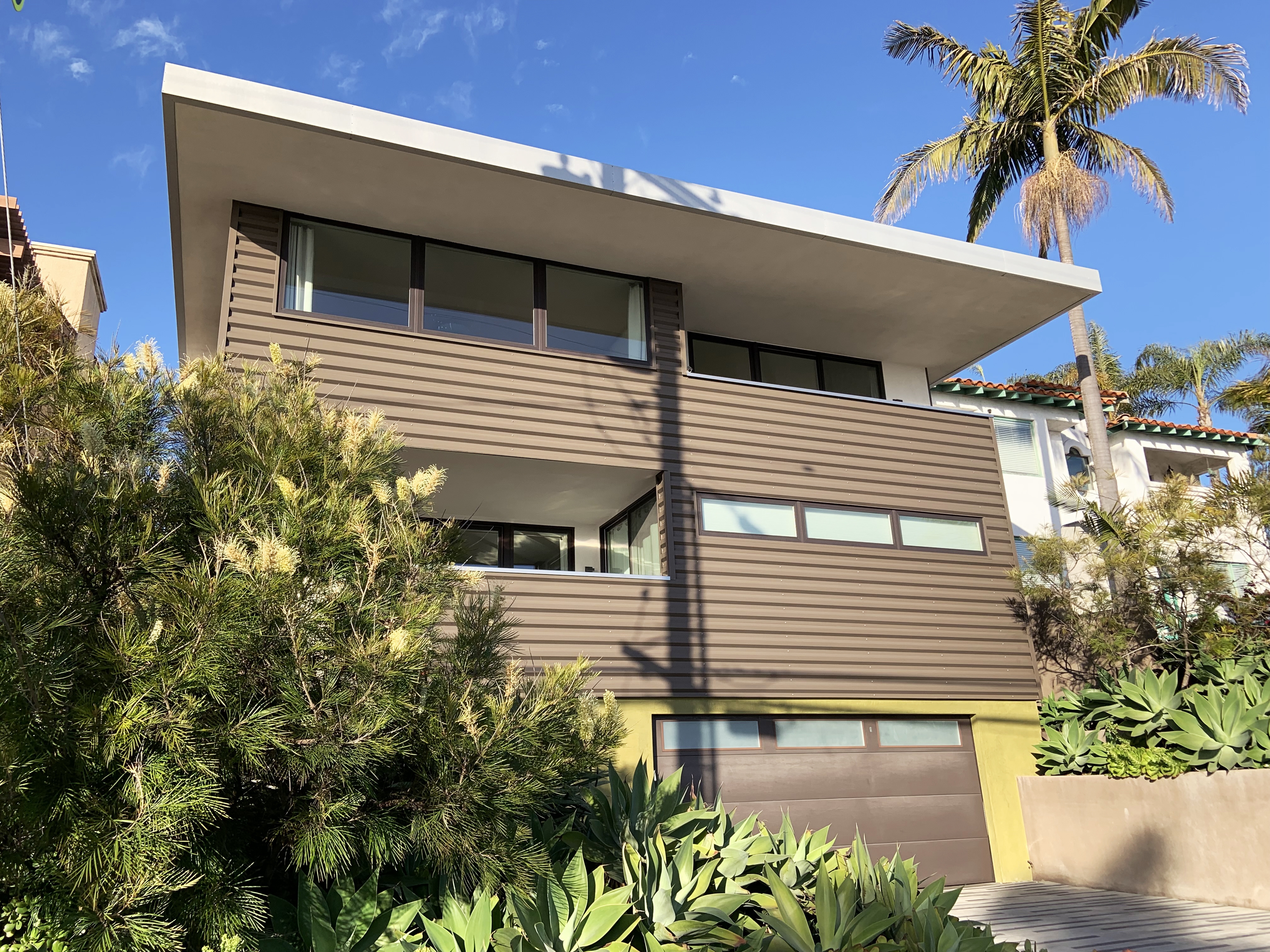caption: The Fortunato's Green Idea House in Hermosa Beach, Calif. has a flat roof with a five foot overhang that shields the sun and cools the home.