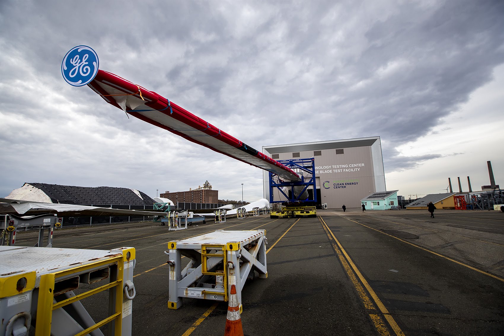 caption: Massachusetts Clean Energy Center and GE unveil the Haliade-X 12MW offshore wind turbine blade at the Wind Technology Testing Center in Boston. (Jesse Costa/WBUR)