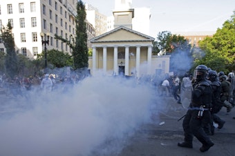 caption: Police move in on demonstrators in Lafayette Square near the White House with tear gas and smoke on June 1. U.S. Park Police made announcements asking protesters to leave, but few people appeared to hear them.
