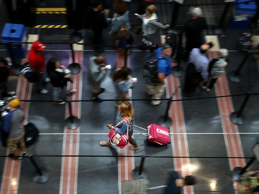 caption: Viruses thrive in the security lines at airports, according to several studies.