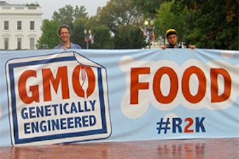 caption: Protesters hold a sign in front of the White House advocating for GMO labeling, October 19, 2011.