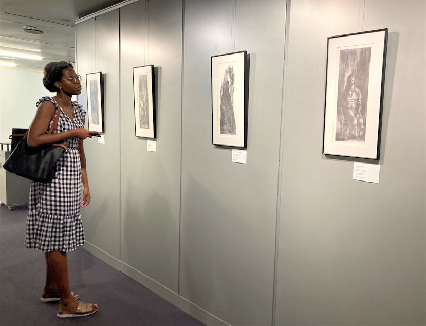 caption: Seattle resident Dellyssa Edinboro browses the "Black Activism in Print" exhibit on July 26, 2023.