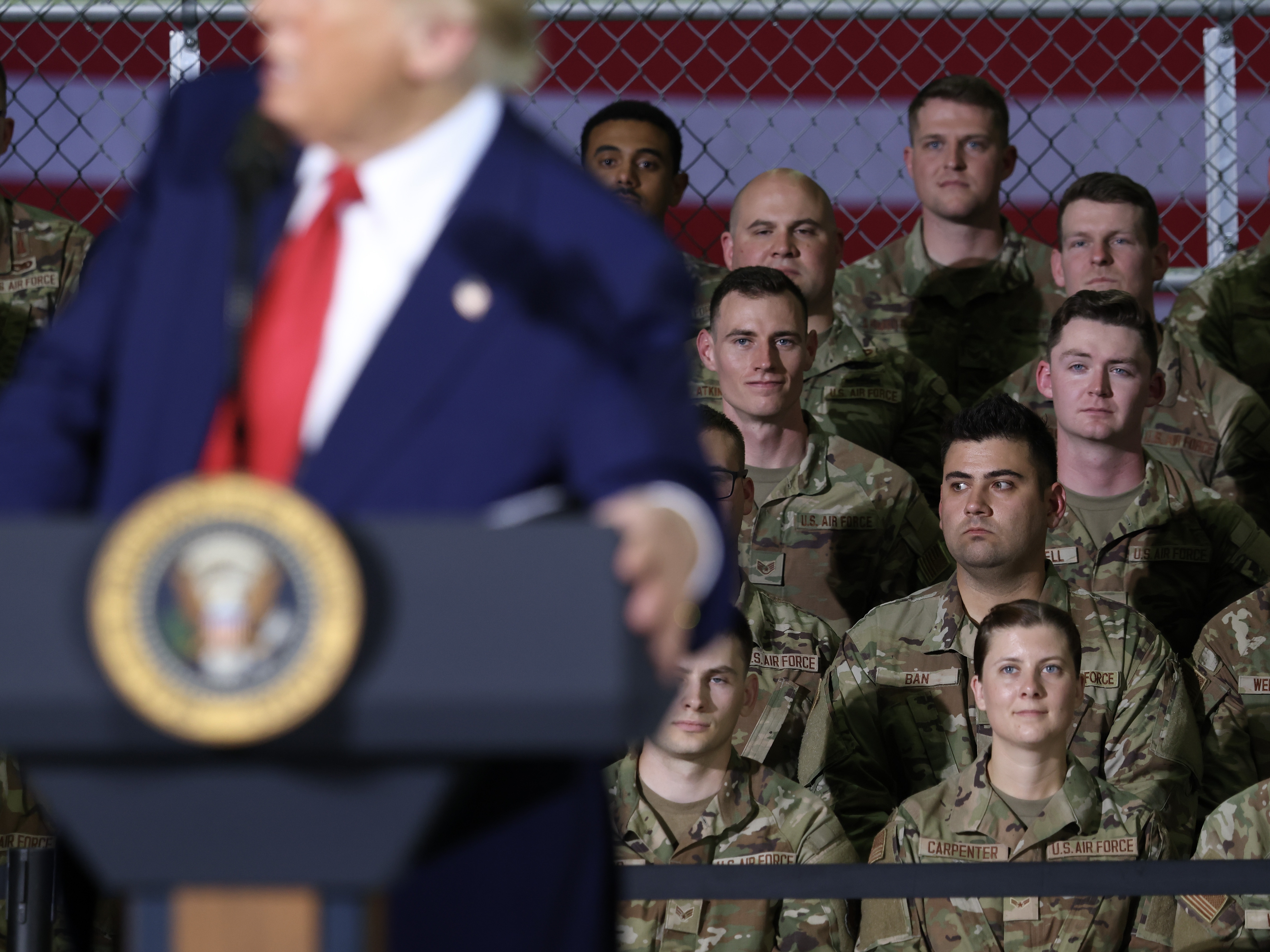 caption: Michigan Air National Guard troops listen as President Trump speaks during a visit with Michigan Air National Guard Troops on April 29 at Selfridge Air National Guard Base, Mich.