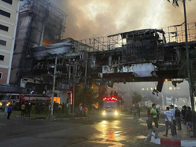 caption: In this photo provided by Cambodia's Fresh News, smoke rises as a fire burns Thursday through the Grand Diamond City Casino and Hotel near a Cambodia-Thai international border gate in Poipet, Cambodia.