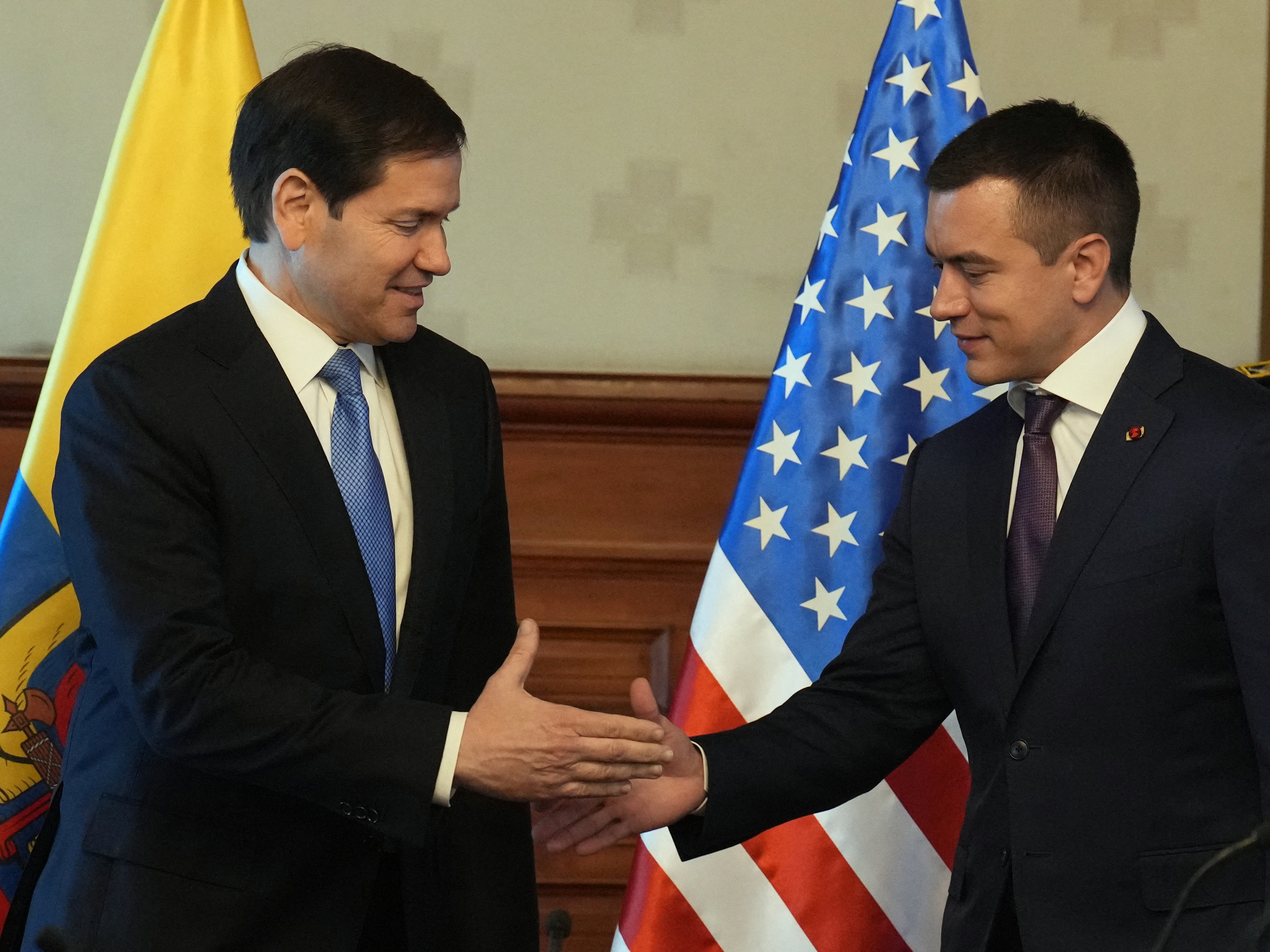 caption: U.S. Secretary of State Marco Rubio (left) and Ecuador's President Daniel Noboa shake hands at the Carondelet presidential palace in Quito, Ecuador, on Thursday.