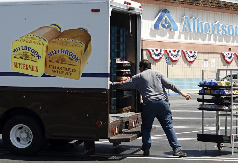 caption: Mitch Maddox, a bread route salesman, loads bread Tuesday, May 30, 2006, outside the Eagle Rock Albertsons store in Los Angeles.
