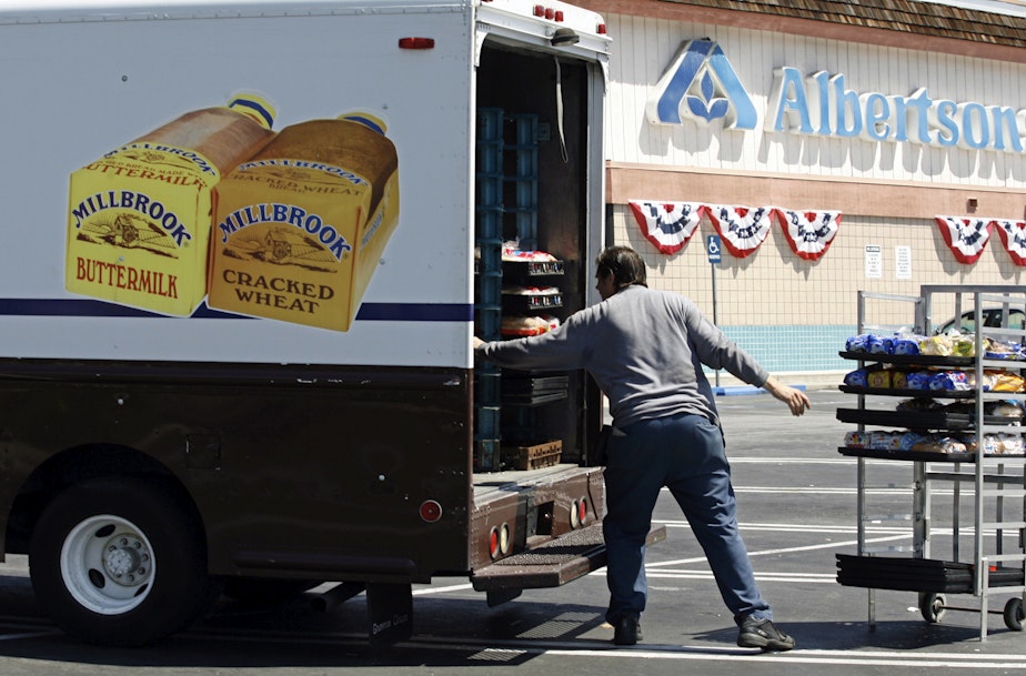 caption: Mitch Maddox, a bread route salesman, loads bread Tuesday, May 30, 2006, outside the Eagle Rock Albertsons store in Los Angeles.