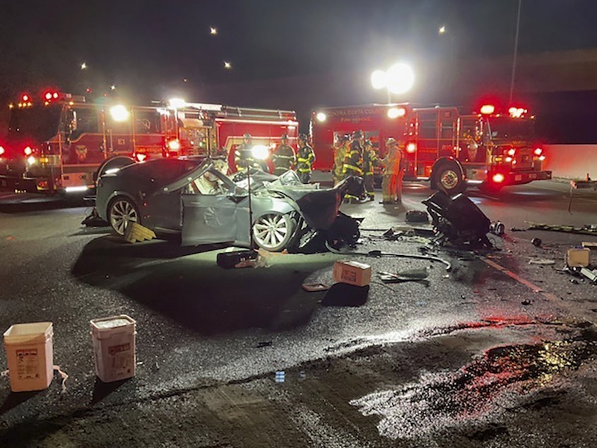 caption: Fire officials said the Tesla driver was killed and a passenger was critically injured Saturday when the car plowed into the firetruck parked on a Northern California freeway.