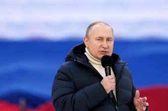 caption: Russian President Vladimir Putin gives a speech at a concert marking the eighth anniversary of Russia's annexation of Crimea at the Luzhniki stadium in Moscow on March 18, 2022.