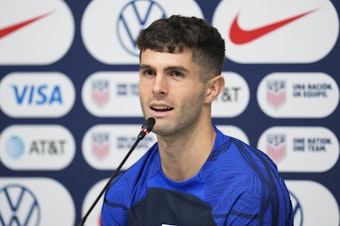 caption: Christian Pulisic of the United States attends a news conference before a training session at Al-Gharafa SC Stadium, in Doha, Thursday, Dec. 1, 2022.