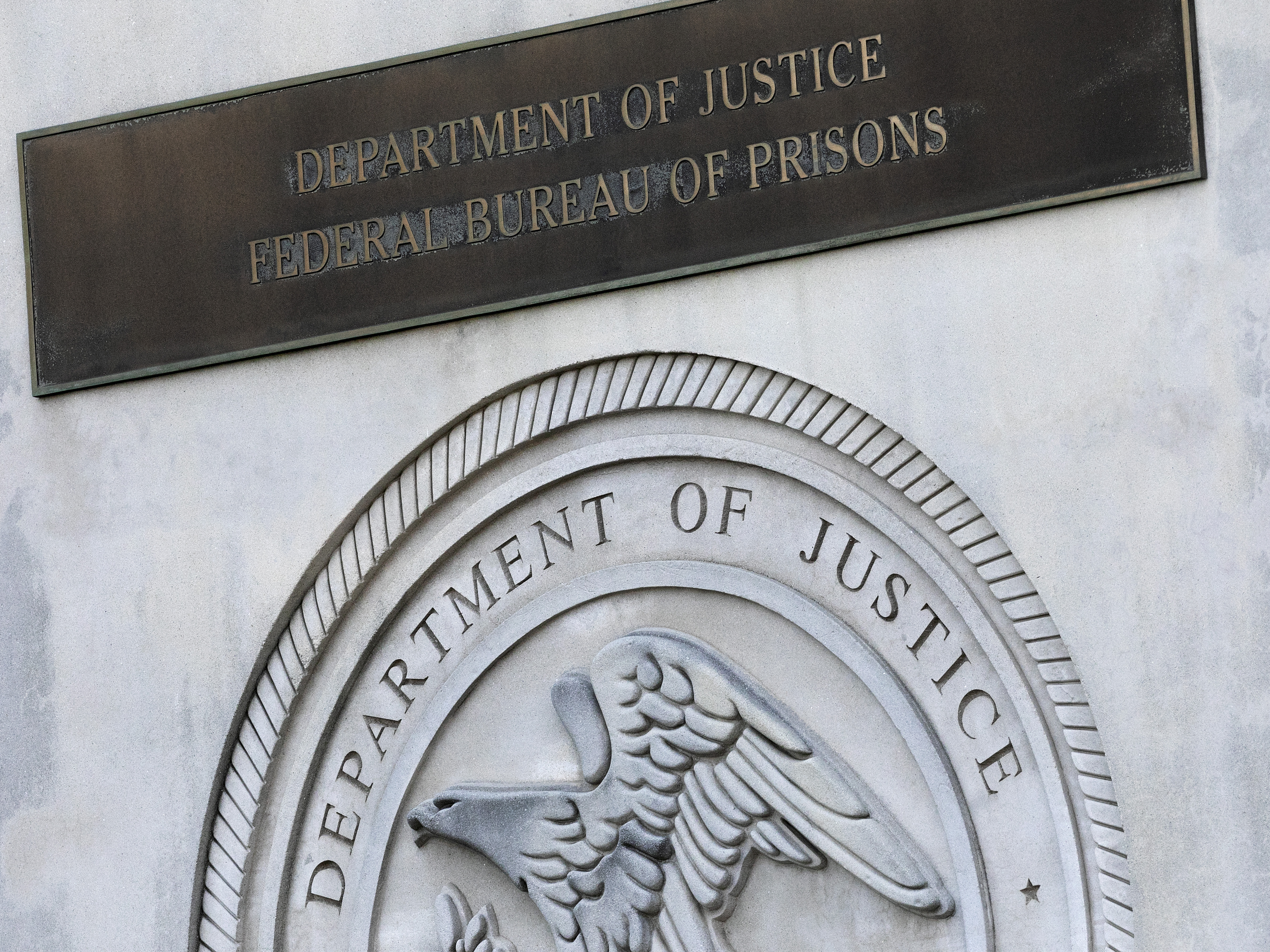 caption: In this July 6, 2020, file photo a sign for the Department of Justice Federal Bureau of Prisons is displayed at the Metropolitan Detention Center in the Brooklyn borough of New York.