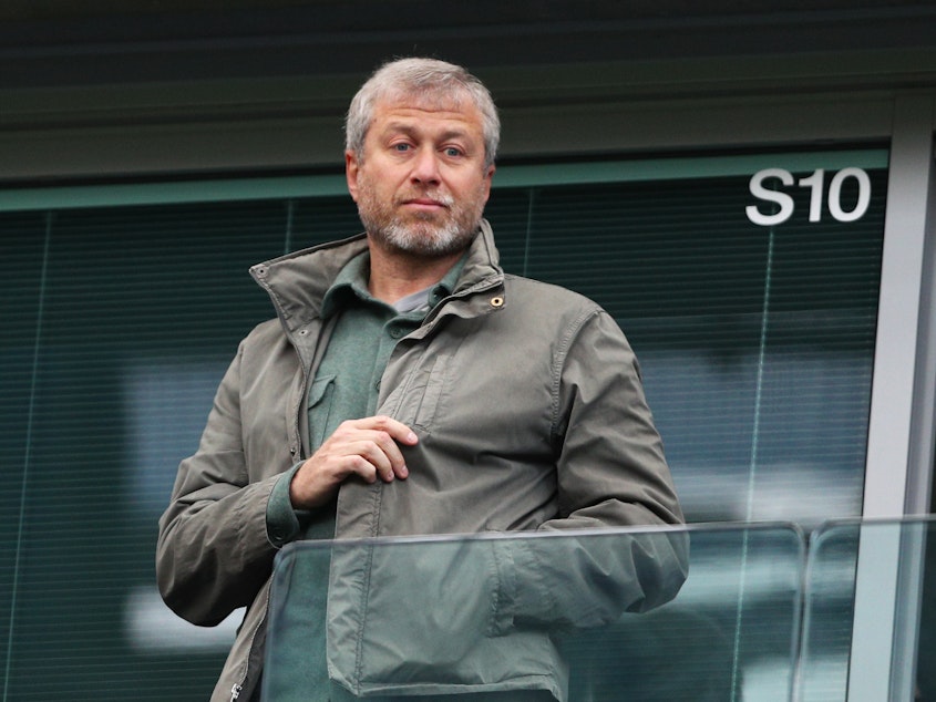caption: Roman Abramovich, pictured at a 2016 match in London, is facing an asset freeze and U.K. travel ban just a week after he announced plans to sell Chelsea Football Club.
