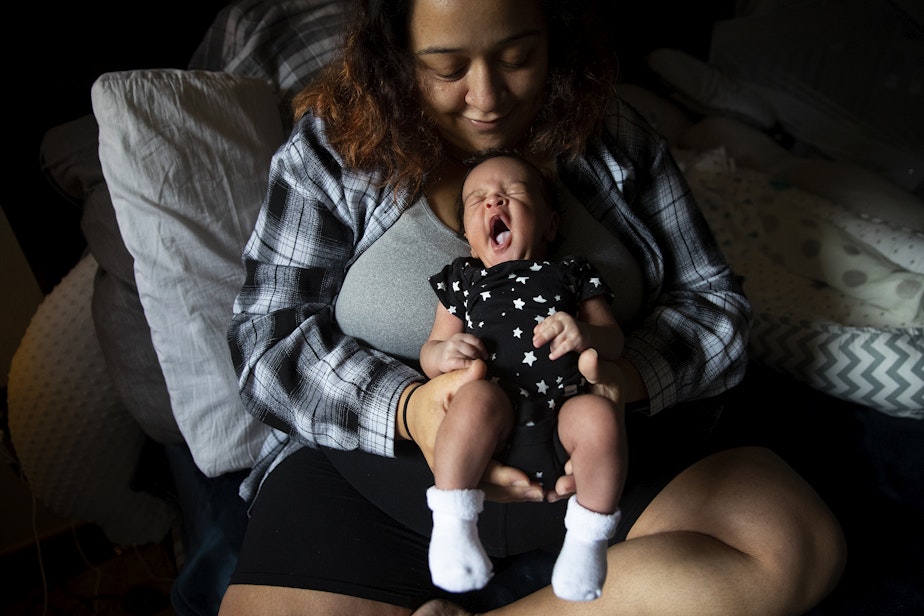 caption: Deita McChristian holds her son Alfred, born at the end of September, on Tuesday, October 17, 2023, at her apartment in Tacoma.