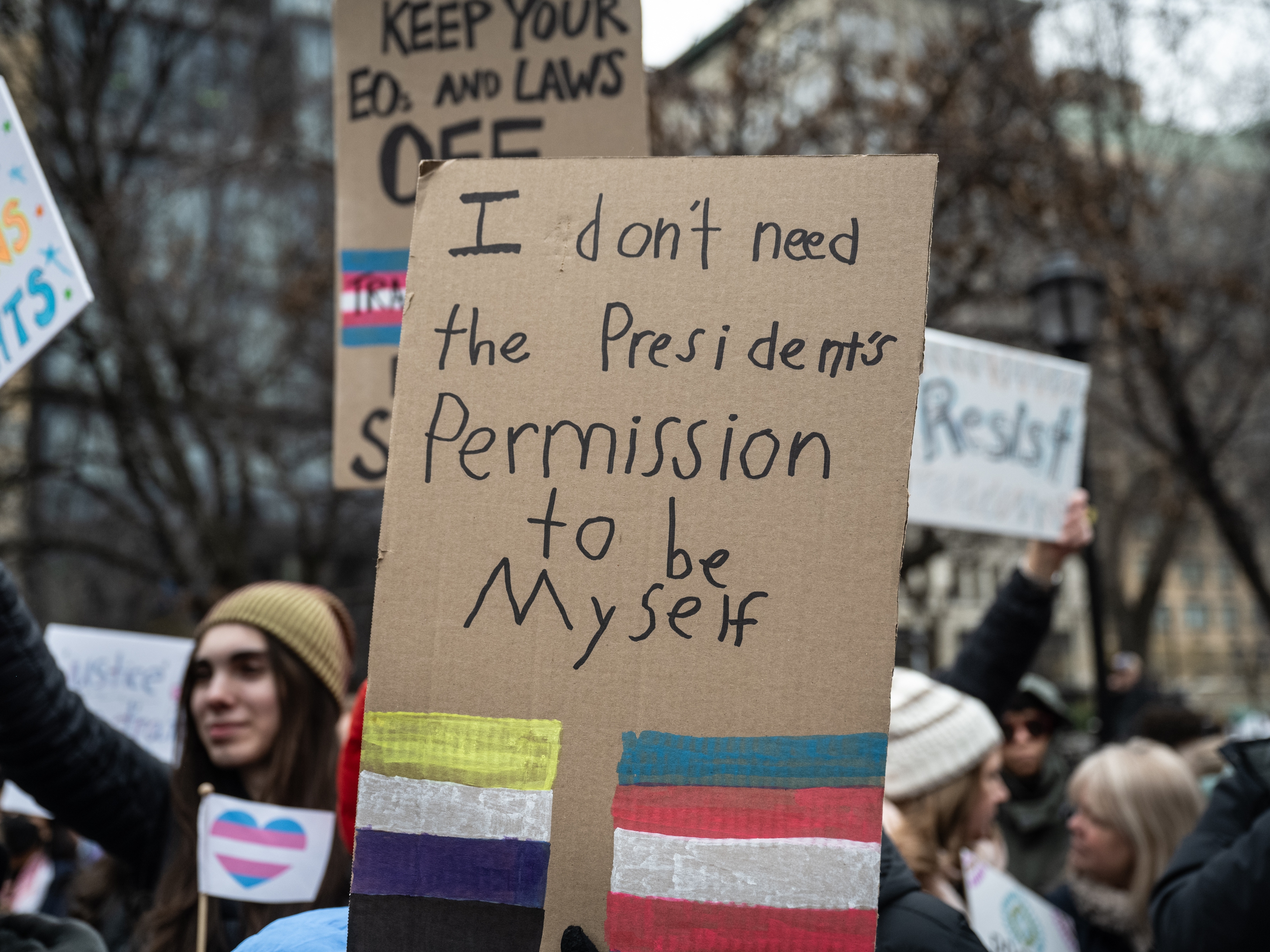 caption: A homemade sign at a rally in Union Square in New York City on Saturday. Various hospitals across the country curbed gender-affirming care for people under 19 after President Trump's executive order.